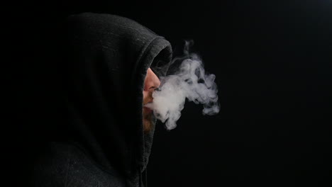 mysterious man exhales vapor