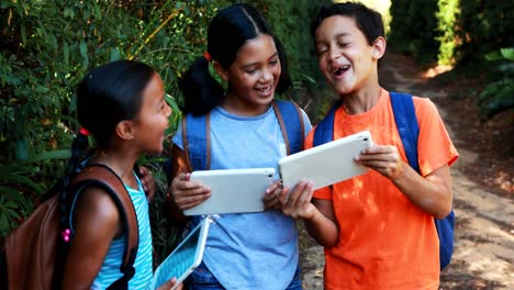 kids using digital tablet in park