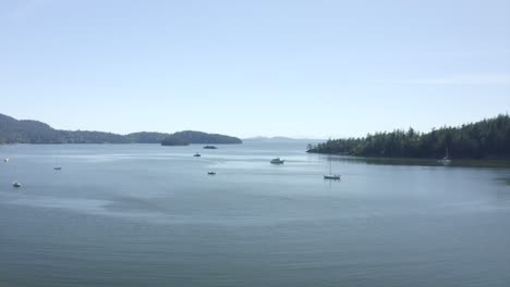 Drone-flying-out-over-puget-sound-sail-boats-in-the-PNW