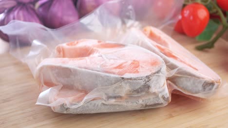 frozen salmon fillet in vacuum packaging with vegetables