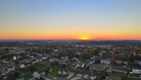 panoramic view of town at sunset with magnificent colorful sky and warm light - aerial drone shot