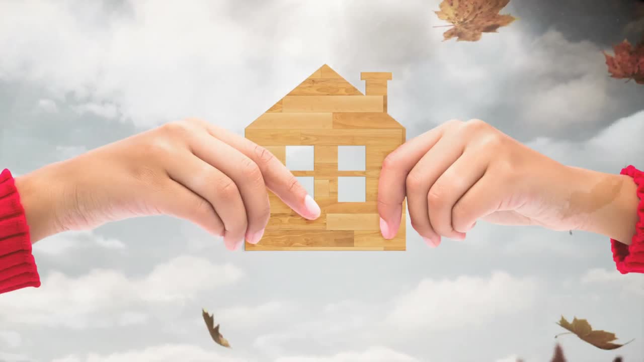 가을 잎 4k에 맞춰 집 로고를 들고 있는 손