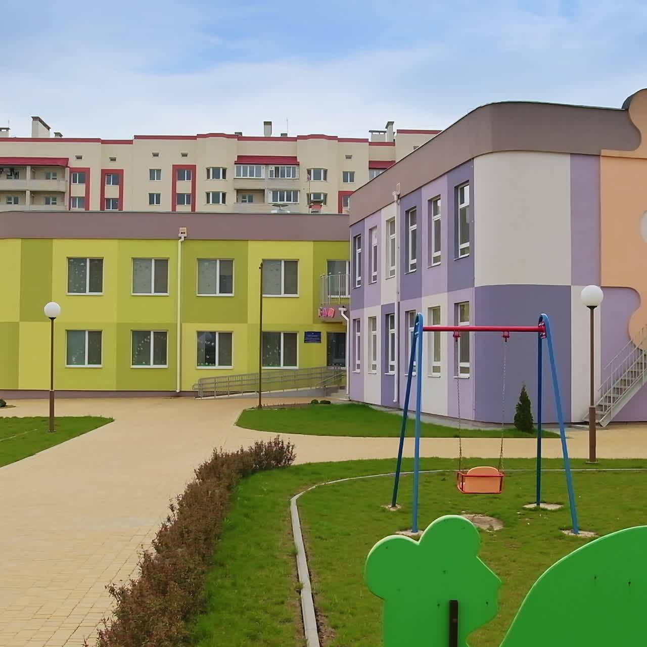 Beautiful buildings of newly-constructed kindergarten. Lovely well-kept territory with adorable playground and swings