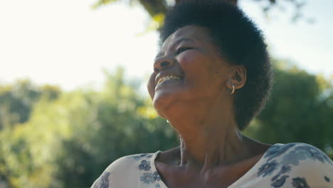 portrait of smiling senior woman standing outdoors in garden park or countryside