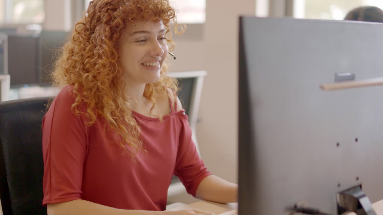 Charming teleoperator talking to a client sitting on a office
