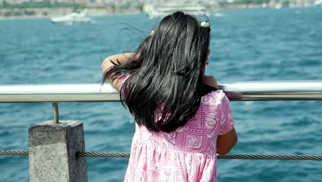 young girl looking at the sea