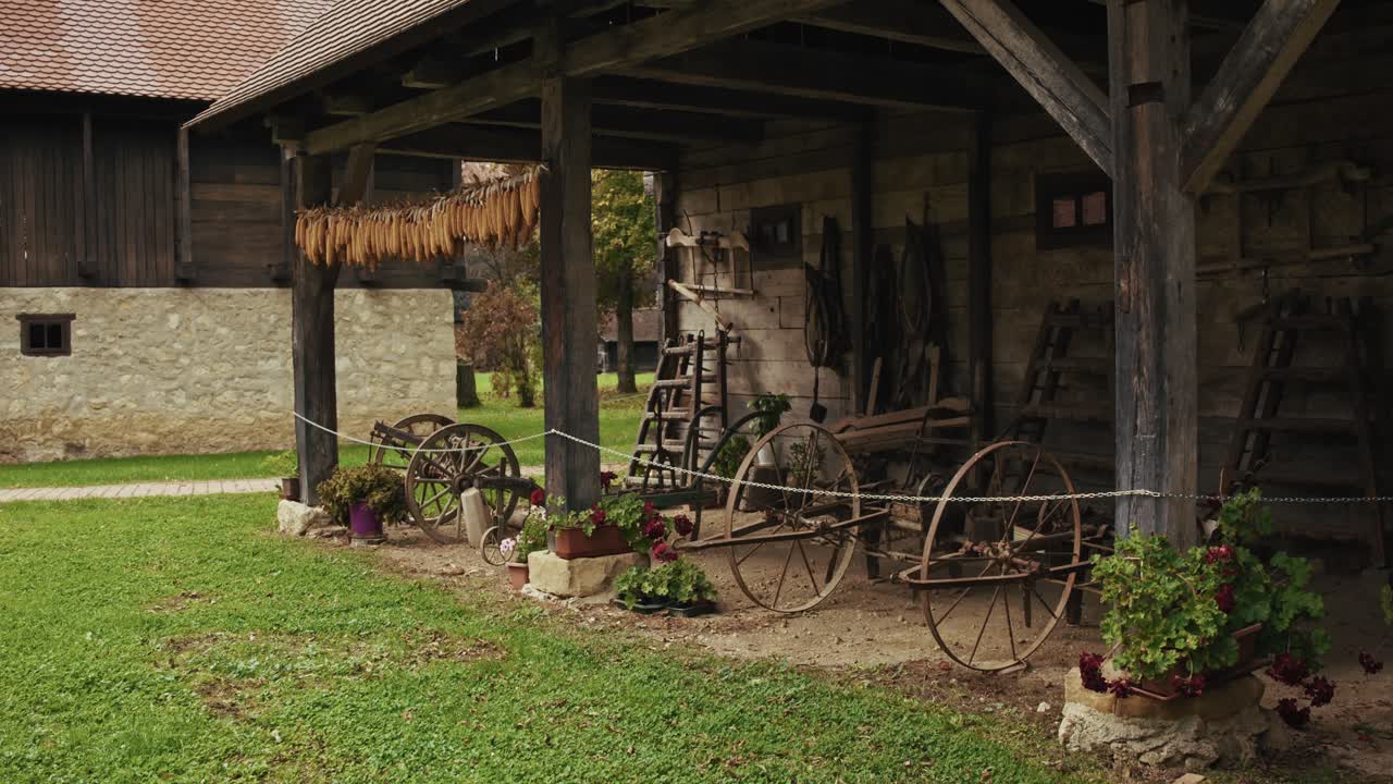 Rustic Croatian shed with old wooden carts and drying corn in Kumrovec village