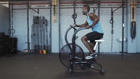 slow motiong of man on resistance bike in gym