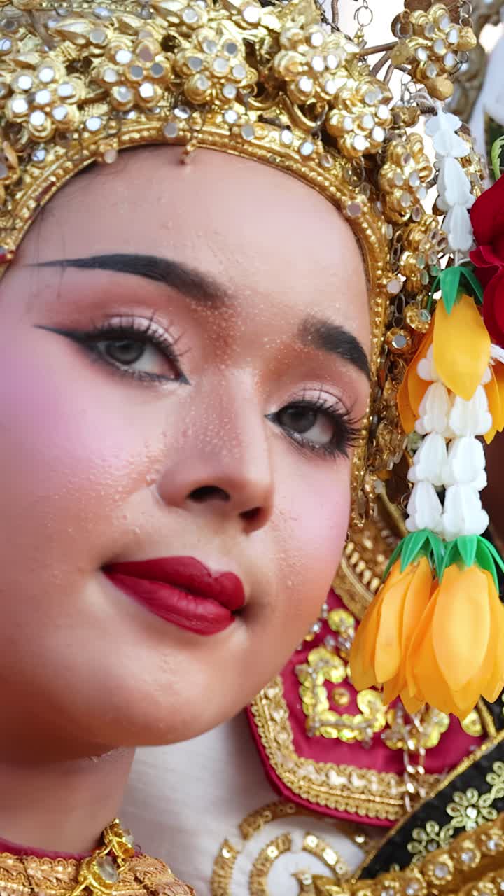A close-up shot captures a Thai Khon dancer wearing intricate golden headwear and makeup