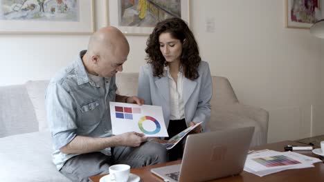 young and mature architects talking with client via laptop