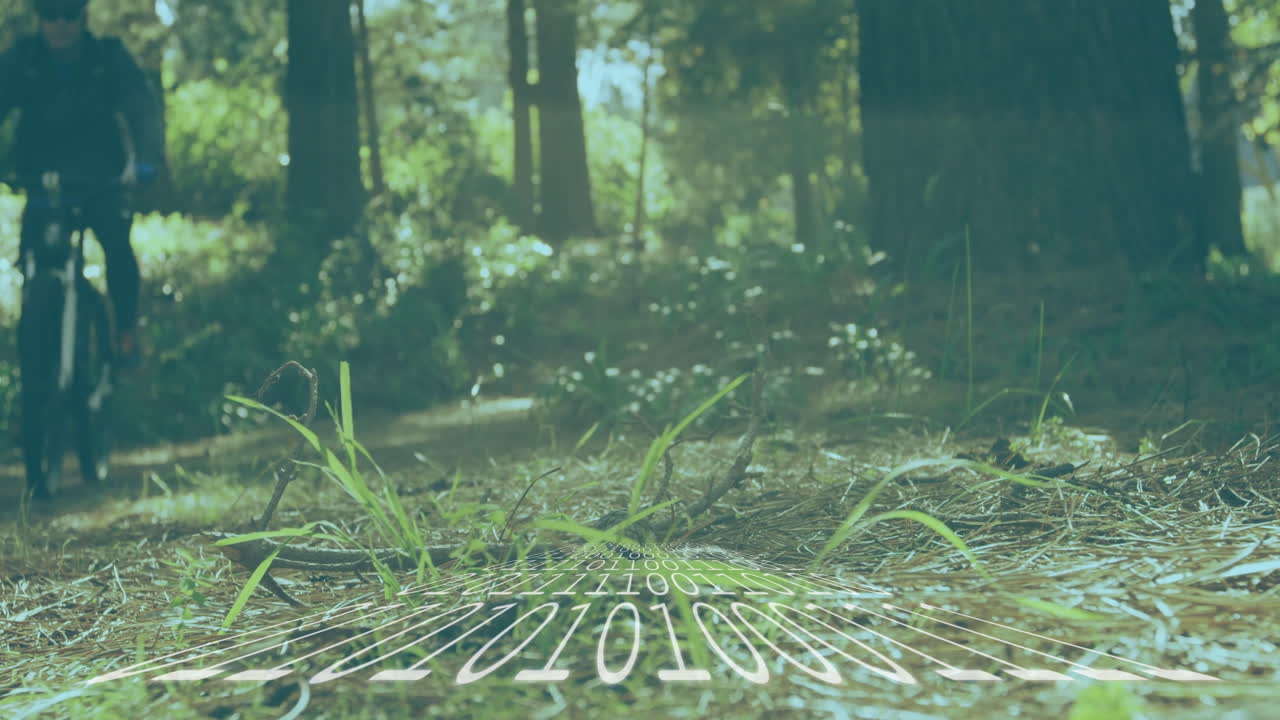Man riding bicycle along forest trail, overlaying digital binary grid showing technology theme