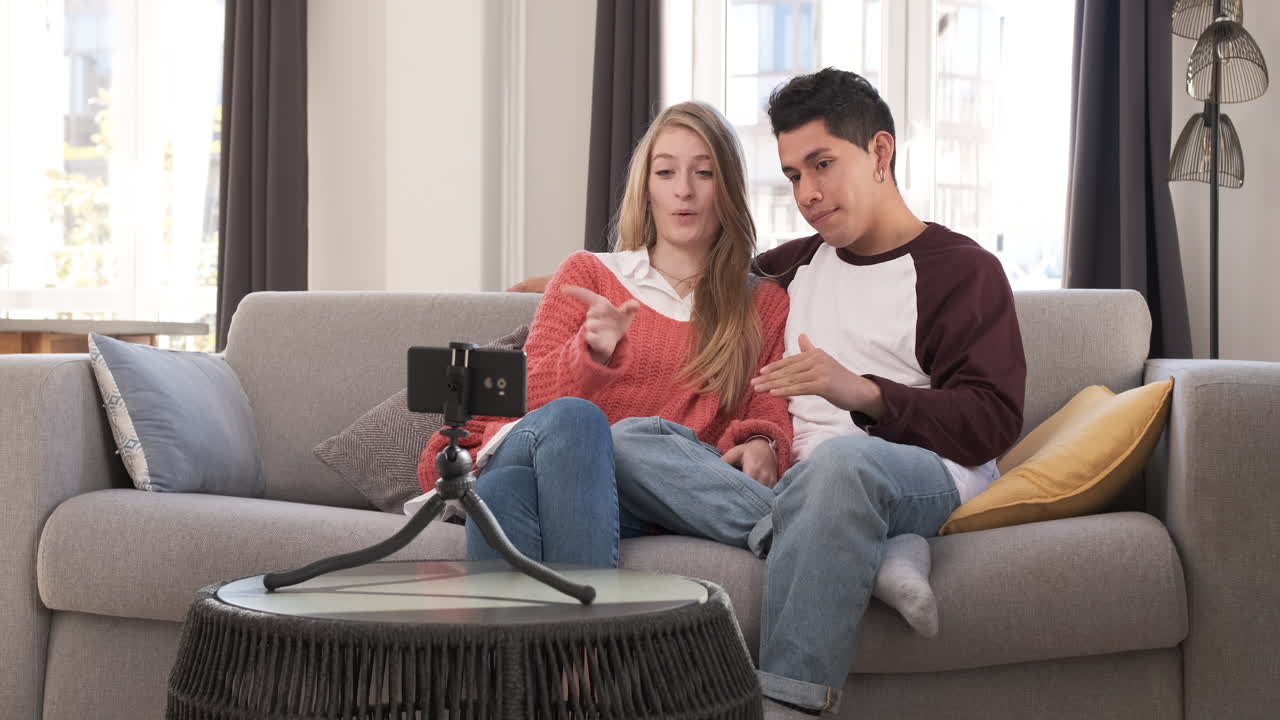Young bloggers creating content for social media while making a video at home.