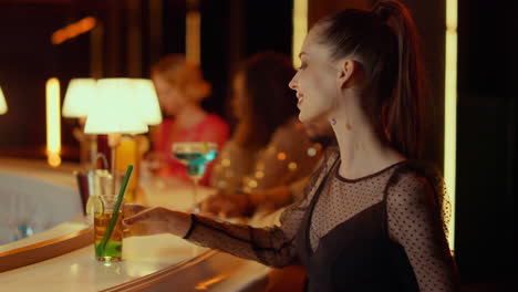 Gorgeous-woman-buying-cocktail-in-nightclub.-Barman-giving-woman-bank-terminal