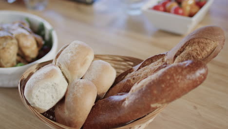 Close-up-of-basket-with-bakeries-and-chicken-on-kitchen-countertop-with-copy-space,-slow-motion