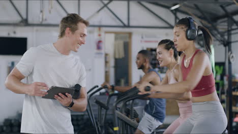 gym instructor giving thumbs up to trainees