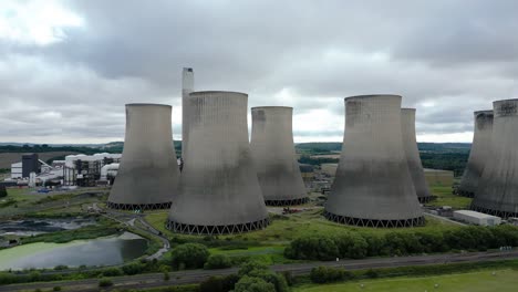 rising aerial view over ratcliffe-on-soar power station cooling towers on rural nottingham countryside