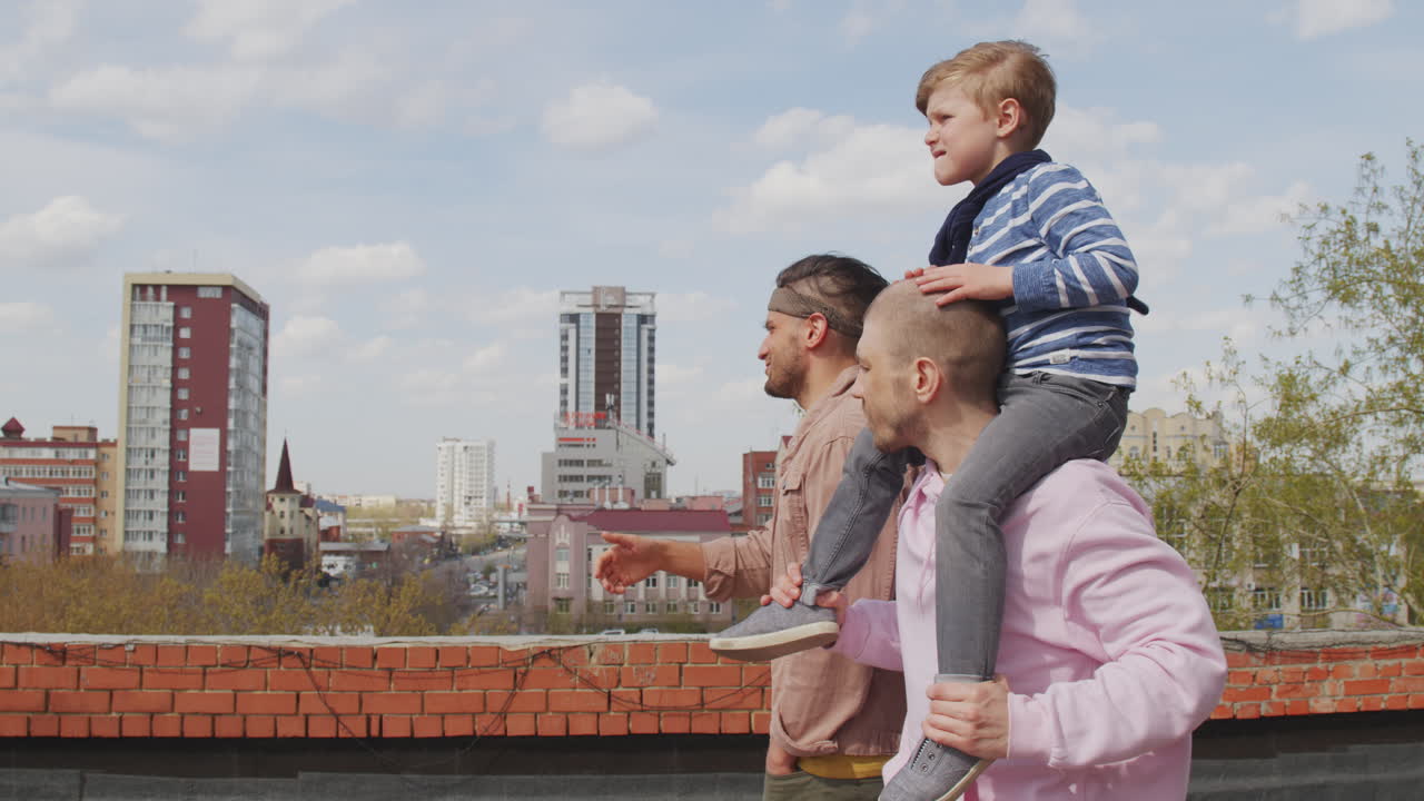 Gay Fathers and Little Son Enjoying Scenery of City
