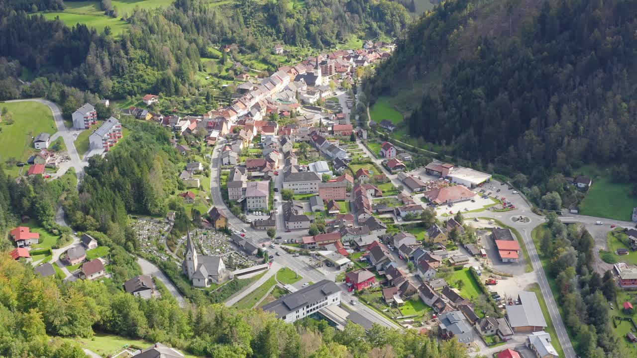 Drone shot of a town surrounded by the lush green mountain landscape at Eisenkappel-Vellach, Austria