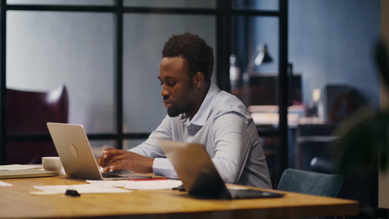 Man working on laptop in modern office