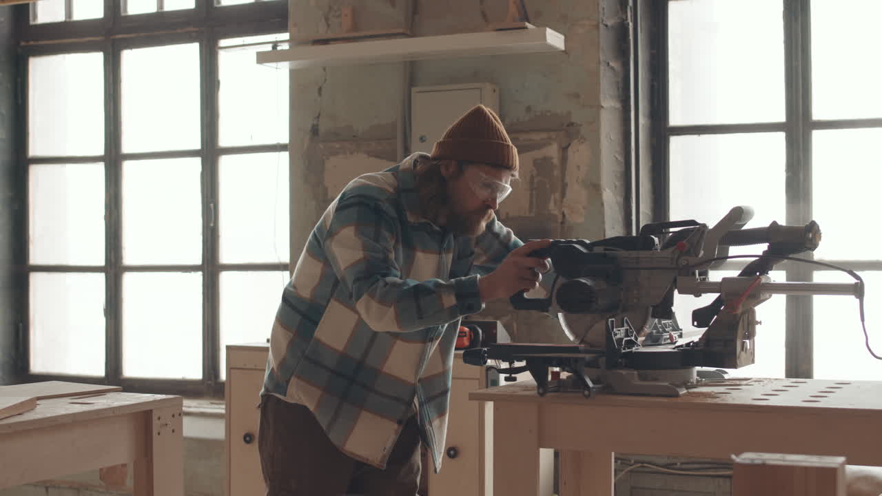 Male Carpenter Using Circular Saw while Working