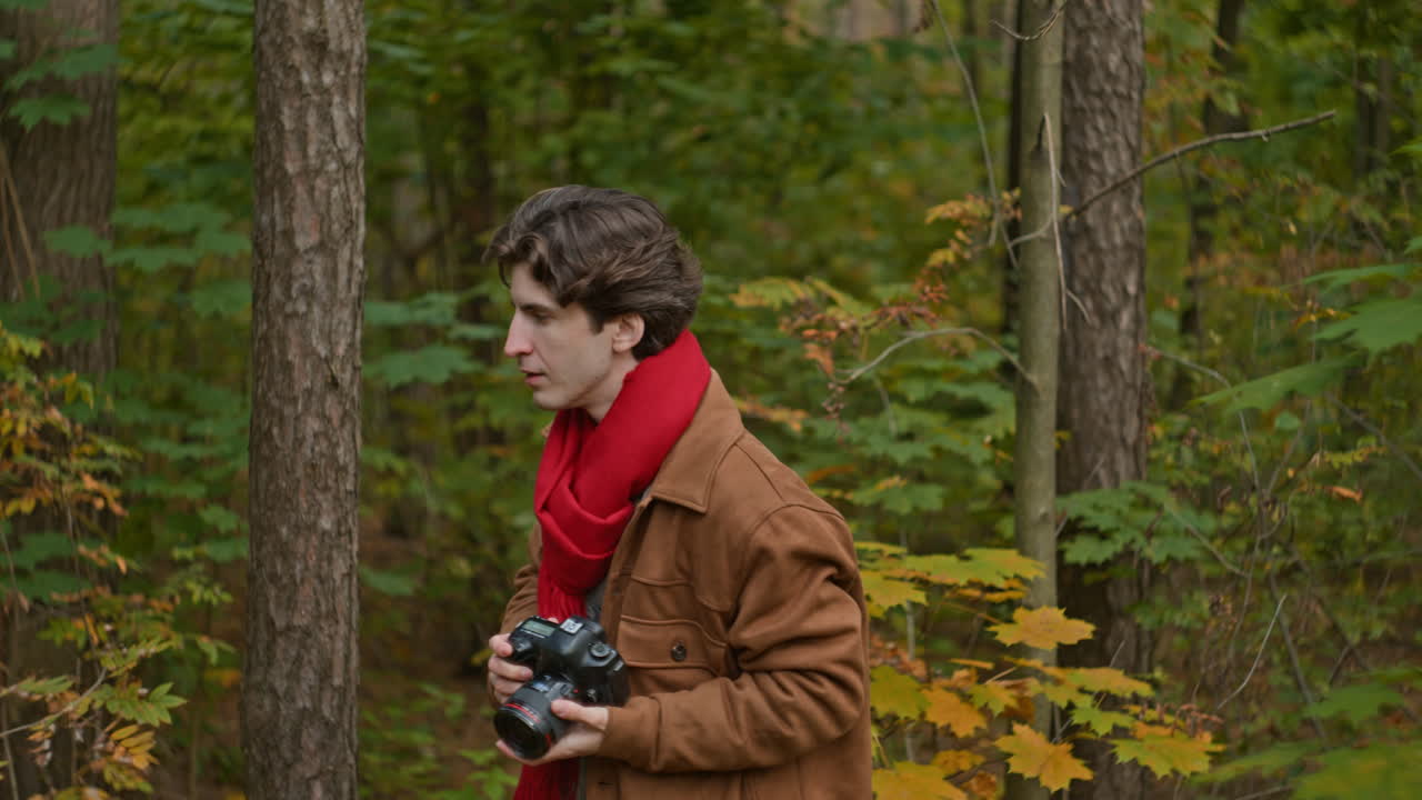 Man with Camera in Autumn Forest