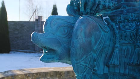 close-up of a teal-colored, ornate fountain sculpture