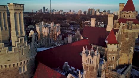 flying over the turrets and red tile roof of a castle at golden hour