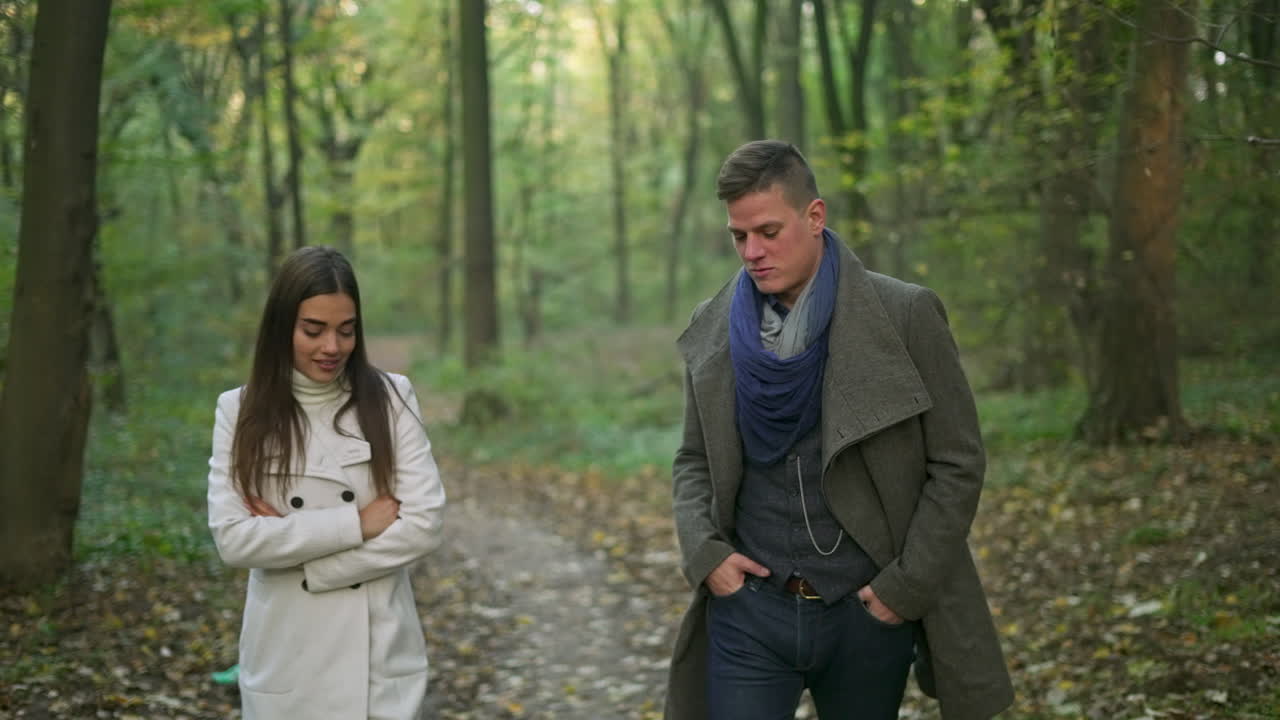 Couple walking in a forest during autumn