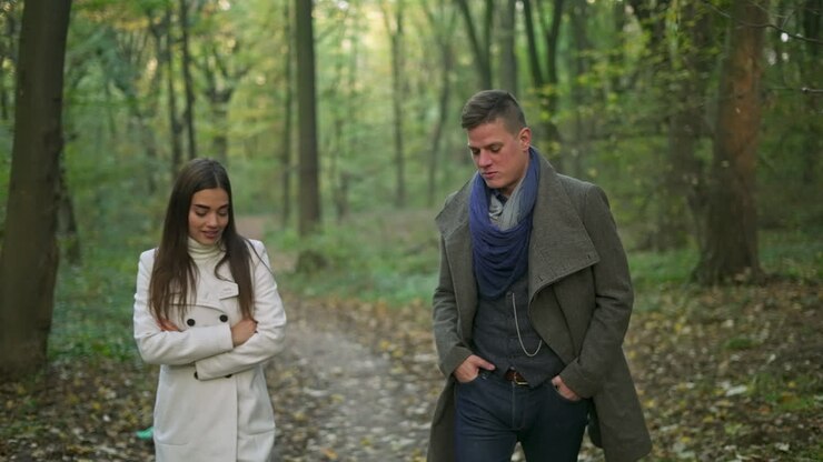 Couple walking in a forest during autumn