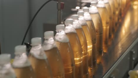 conveyor belt with bottles for juice or water at a modern beverage plant. modern production of sweet soda water