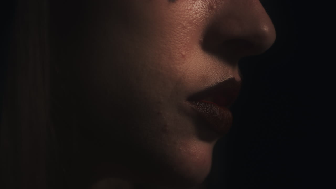 Closeup Profile of Meditating Woman's Face Mouth Chanting with Black Background