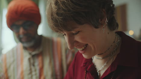 woman cooking food during culinary class with indian chef in kitchen