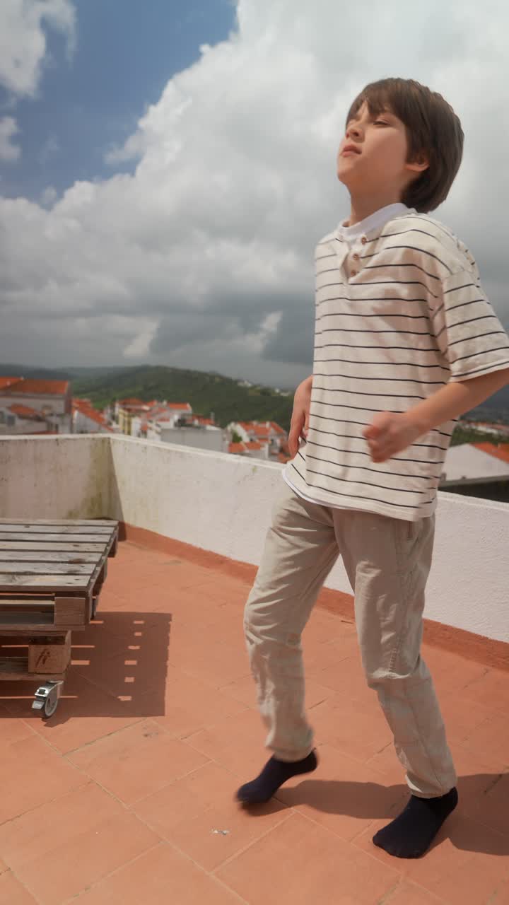 Boy walking on a rooftop