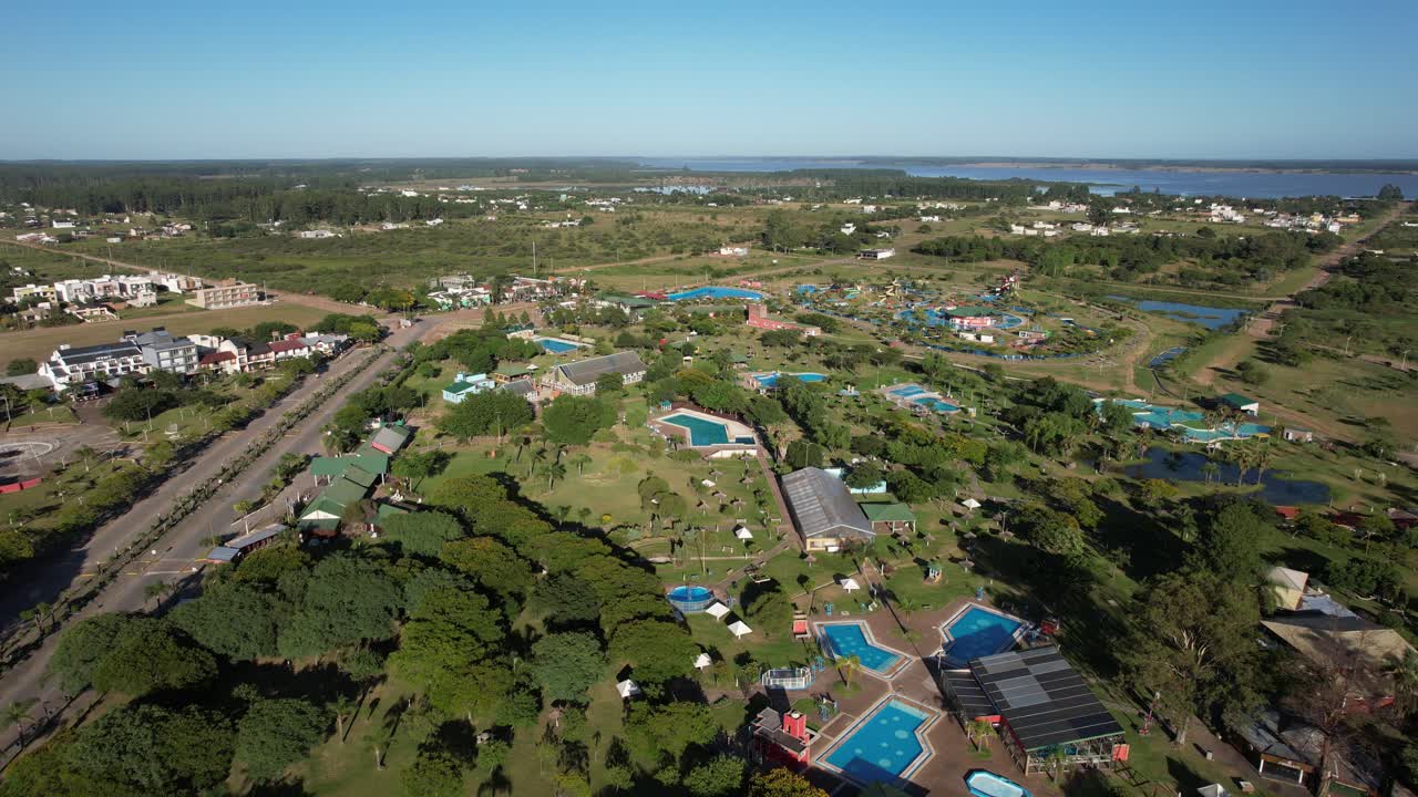 forward movement with drone showing several hotels and inns near the Salto Grande dam, in Argentina, soft dawn light