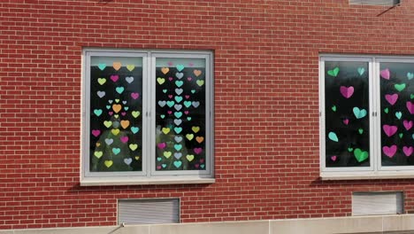 aerial view of hearts and healthcare workers at hospital during lockdown due to virus