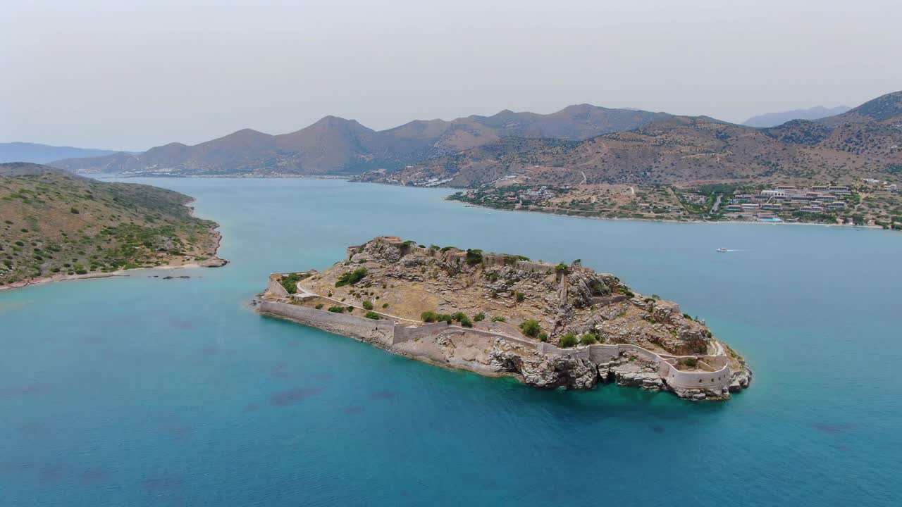Establishing view of Spinalonga island, waters and landscape, Crete, Greece, aerial