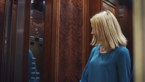 opening mirror lift doors and young woman coming into elevator car