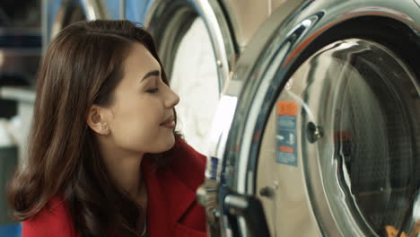 Close-Up-Of-Pretty-Woman-Taking-Out-Clean-Clothes-From-Washing-Machine