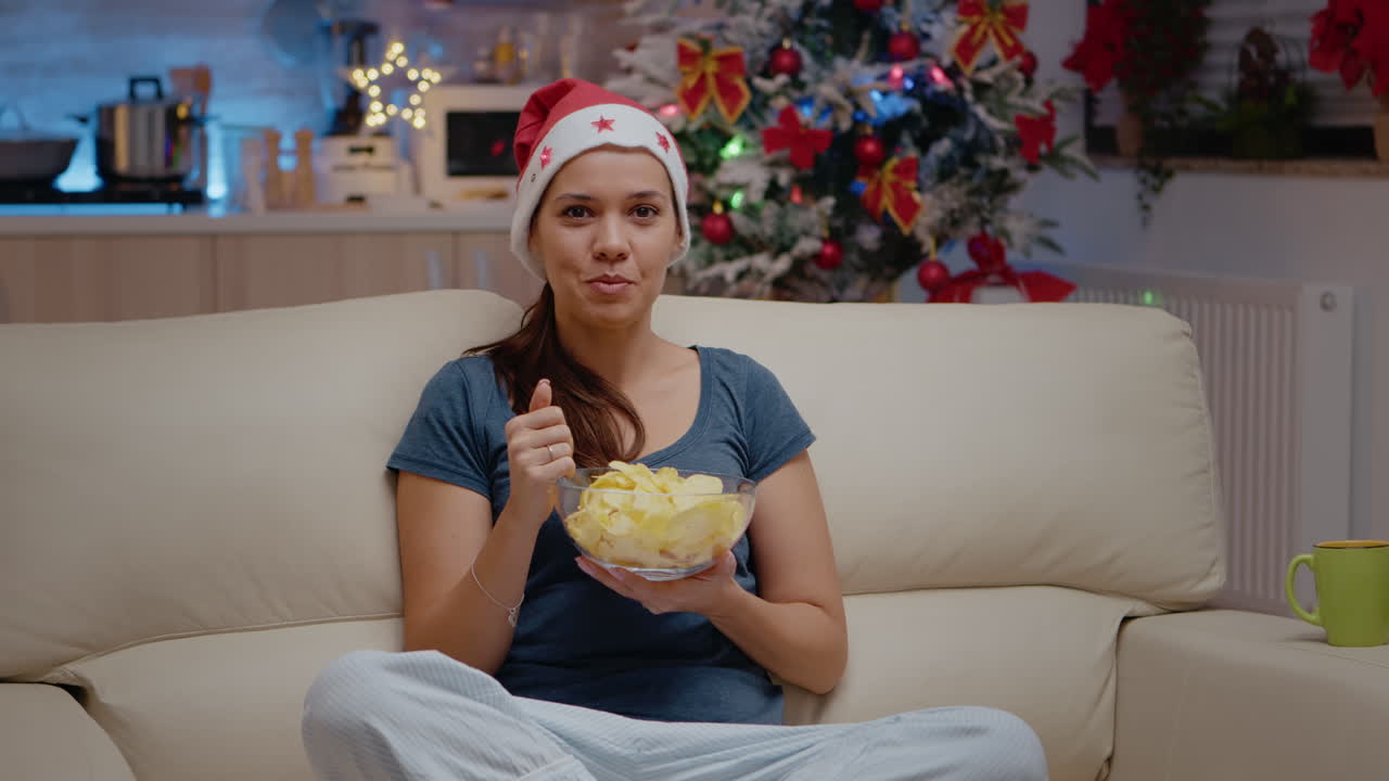 POV of woman using video call communication and eating chips