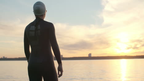 woman dressed in wetsuit and swimming cap