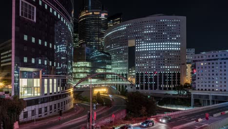 night traffic between towers of la defense business district paris