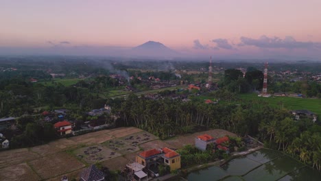 pink's sunset with the volcano mount agung in the background - ubud, bali - indonesia