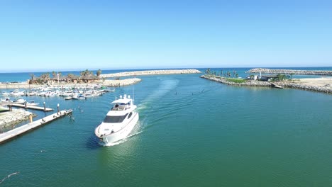 aerial drone shot of a yacht arriving to the marina of san jose del cabo, baja california sur