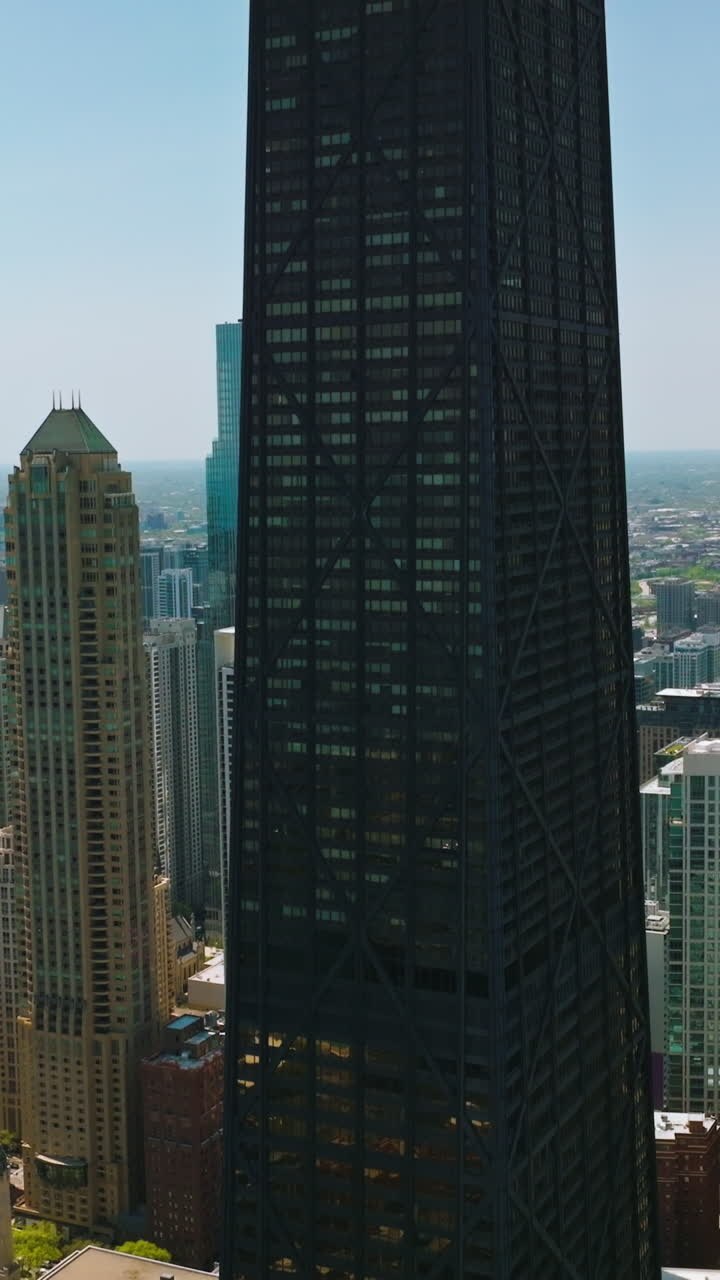 Skyscrapers of amazing Chicago. Drone shot rising along the outstanding city against blue sky backdrop. Vertical video