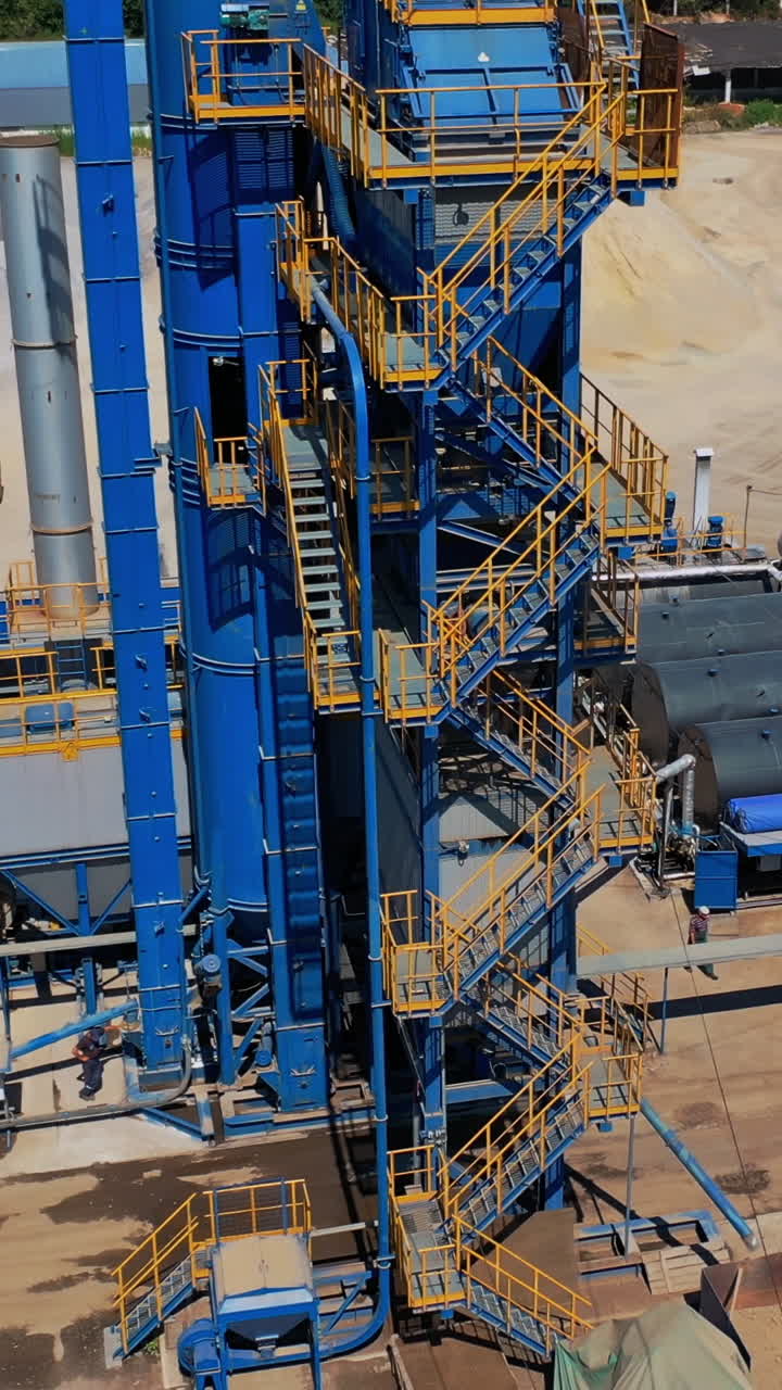 Construction site top view. Aerial view over the building materials processing factory Vertical video
