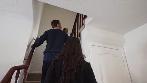 young real estate agent showing first time home buyers a beautiful home.