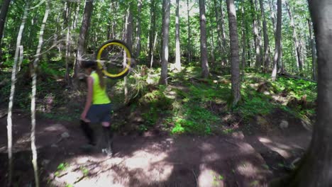 Woman-carrying-unicycle-and-passing-through-the-forest-4k