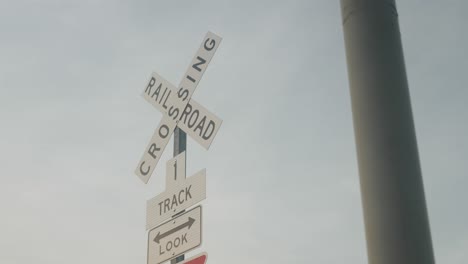 railroad crossing warning sign on a pole