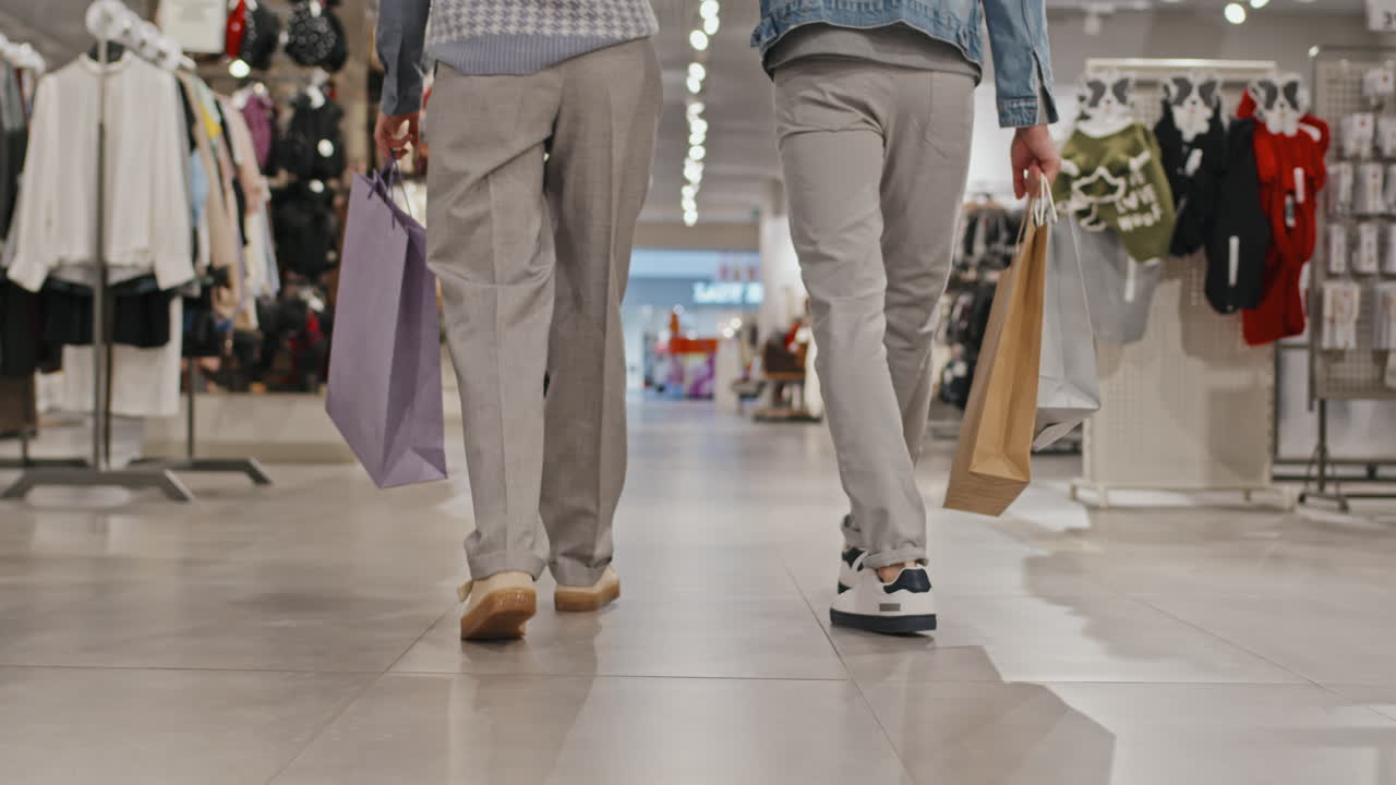 Stylish Young Couple Shopping For Clothes Together