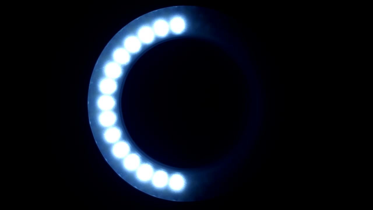 The ring from LED in the lamp lights up in different modes on a black background